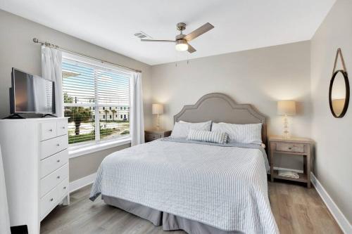 a white bedroom with a bed and a window at Just listed, stroll to beach, 2 pools, Pickleball in Santa Rosa Beach
