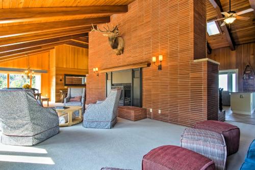 a living room with chairs and a wall with a deer head on it at 7-Acre Coastal Michigan Home with Hot Tub and Sauna! in Ludington