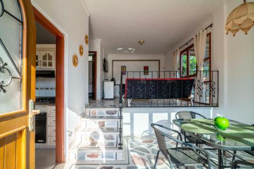 a dining room with a table and chairs on a balcony at Hotel Cabañas Villa Roca, Rodadero in Santa Marta