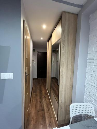 a hallway with a mirror and a bed in a room at Luxury apartaments Klimatyzacja in Radom