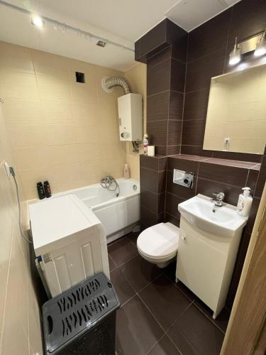 a bathroom with a white toilet and a sink at Luxury apartaments Klimatyzacja in Radom