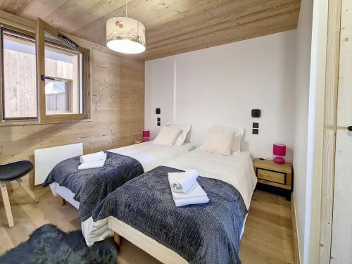 une chambre avec deux lits et une fenêtre dans l'établissement Chalet Neuf · Proche Pistes · Terrasse · Sauna - FR-1-344-1161, à Praranger