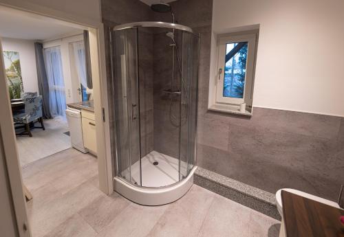 a bathroom with a shower and a sink at Ferienwohnung Einraum Apartment Pusteblume in Eilenburg