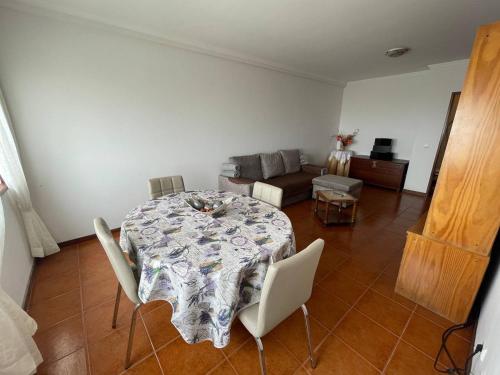 a living room with a table and a couch at Farol Nascente in Lavra
