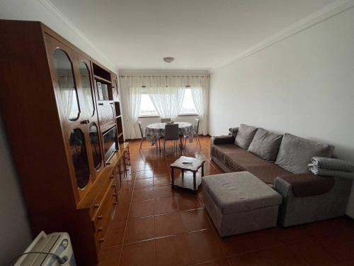 a living room with a couch and a table at Farol Nascente in Lavra