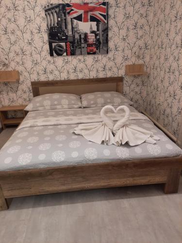 a bedroom with a bed with a bow on it at Hotel Boršičanka in Havířov