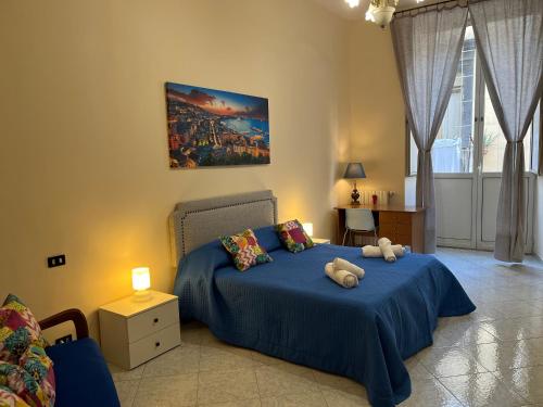 um quarto com uma cama azul com animais de peluche em Dimora San Ferdinando em Nápoles