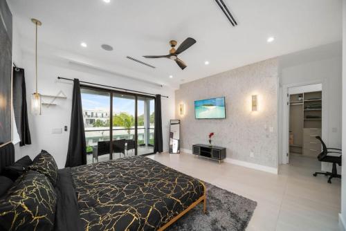 a bedroom with a bed and a ceiling fan at The Elements Luxury Home Fort Lauderdale in Fort Lauderdale