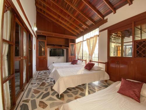 聖瑪爾塔的住宿－Villa Roca, Rodadero，一间卧室配有两张床和一台平面电视