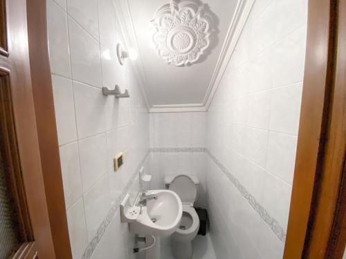a small bathroom with a toilet and a sink at Hotel Cabañas Villa Roca, Rodadero in Santa Marta