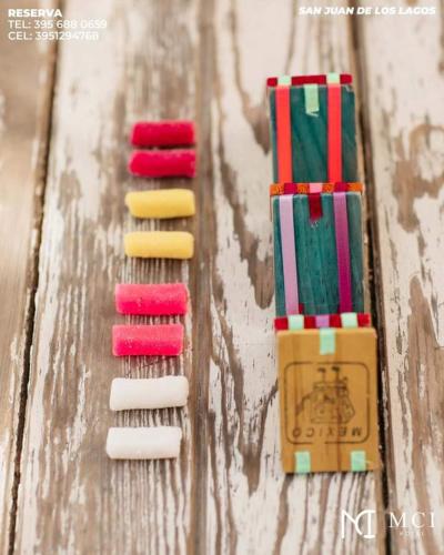four different colored tooth brushes on a wooden table at MCI HOTEL in San Juan de los Lagos