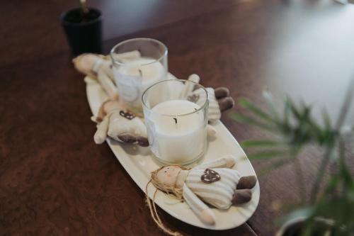 a white plate with candles and cookies on a table at Apartments Možinetova hiša in Šentjošt nad Horjulom