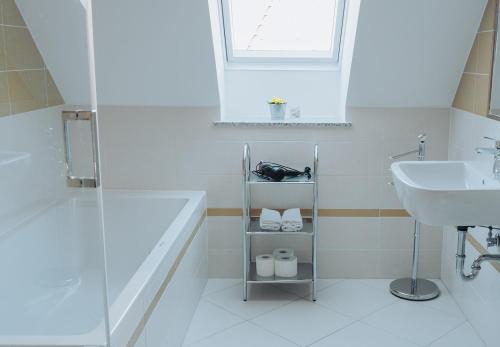 a bathroom with a sink and a bath tub and a sink at Apartments Možinetova hiša in Šentjošt nad Horjulom