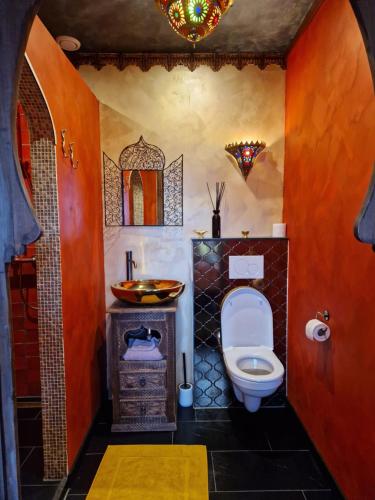 a bathroom with a toilet and a sink at Riad Agraba, 1001 nights in Lomm