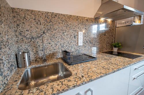 a kitchen with a sink and a counter top at Apartamento 2 en la muralla romana junto a la Catedral in Tarragona