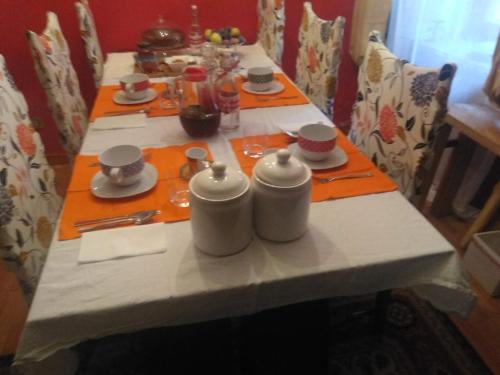 a table with plates and utensils on it at B&B Ma Maison in Govone