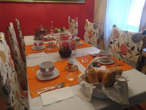 a table with a plate of food on it at B&B Ma Maison in Govone