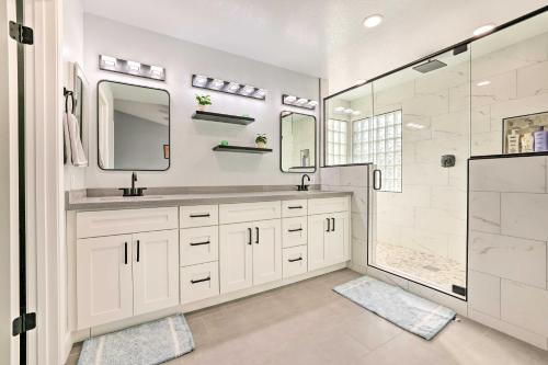 a white bathroom with a sink and a shower at Chandler Home with Yard and Grill 3 Mi to Downtown! in Chandler