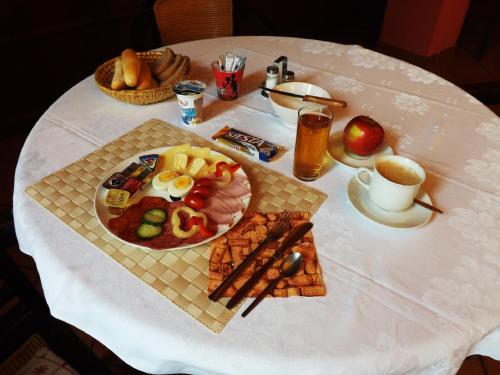 a white table topped with plates of food at Hotel Avion in Prostějov