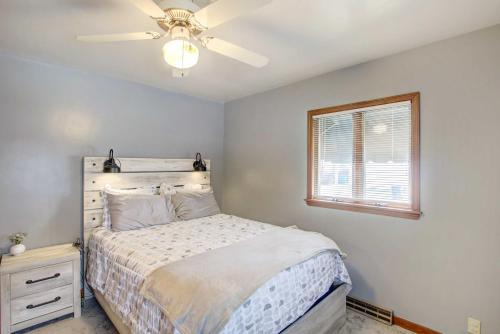 a bedroom with a bed and a ceiling fan at Cozy Wisconsin Abode Walk to Lake Michigan! in Algoma