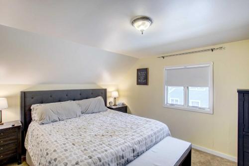 a bedroom with a bed and a window at Cozy Wisconsin Abode Walk to Lake Michigan! in Algoma