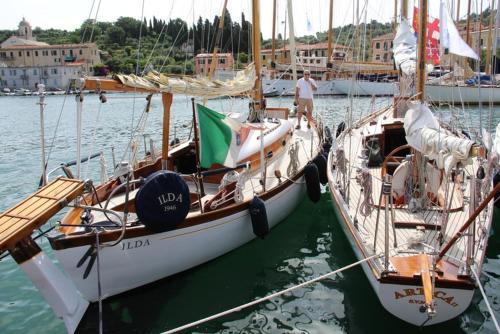 two boats are docked in the water in a harbor at Il Profumo Dellegrazie in Le Grazie