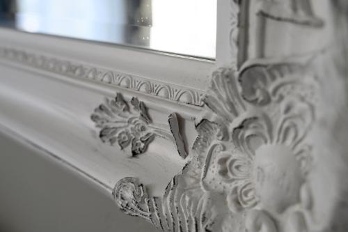 a close up of a wall with a mirror at The Grove Cromer in Cromer