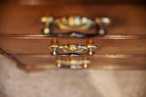 a close up of a gold ring on a wooden drawer at The Grove Cromer in Cromer