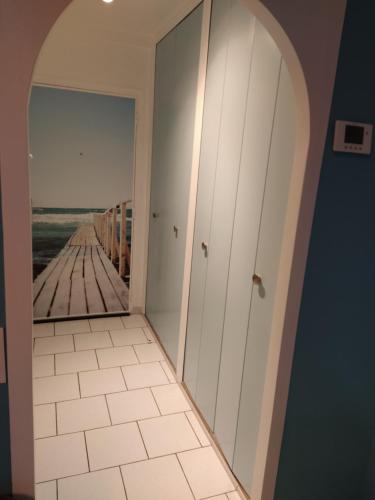 a room with a hallway with a reflection of a pier at Abri Côtier-3 étoiles-vue imprenable sur port de plaisance in Fécamp