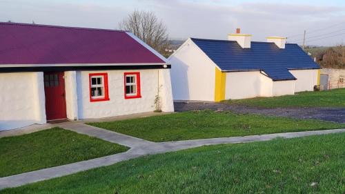 a house with a red door and a blue roof at Tiernan's Luxury Accommodation in Newtown-Dillon