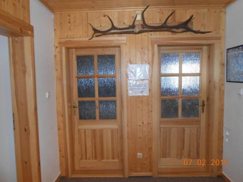 a pair of doors with windows in a room at Sykorova Chalupa in Suchá Rudná
