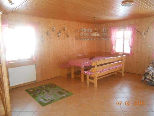 a room with a table and a bench in a room at Sykorova Chalupa in Suchá Rudná