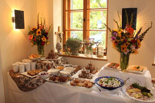 a table with a buffet of food on it at Romantik Hotel Chalet am Kiental in Herrsching am Ammersee