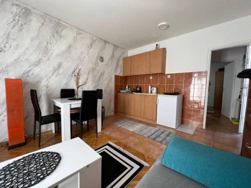 a living room with a table and a kitchen at Vuk in Zlatibor