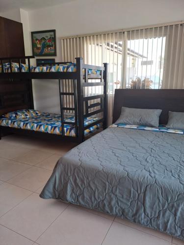 a bedroom with two bunk beds in a room at Villa Layla Santa Marta in Santa Marta