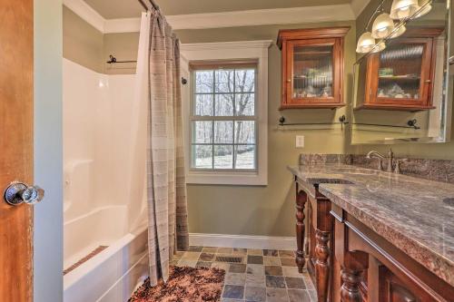 a bathroom with a shower and a sink and a tub at Secluded Getaway Home with Trails and Waterfall! 