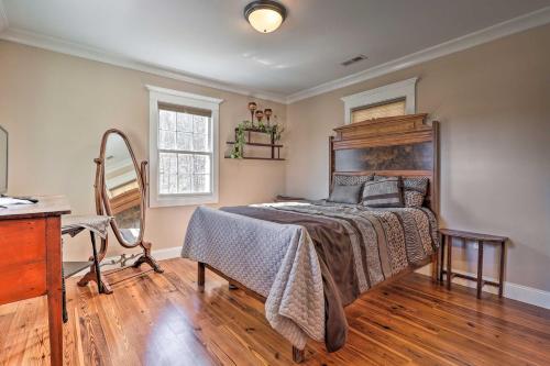 a bedroom with a bed and a desk and a window at Secluded Getaway Home with Trails and Waterfall! 