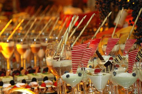a row of wine glasses with food and drinks at Romantik Hotel Chalet am Kiental in Herrsching am Ammersee