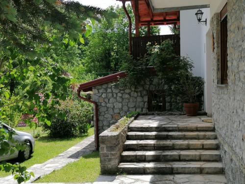 a set of stairs leading up to a house at PLITVICE KONAK Daic in Plitvička Jezera