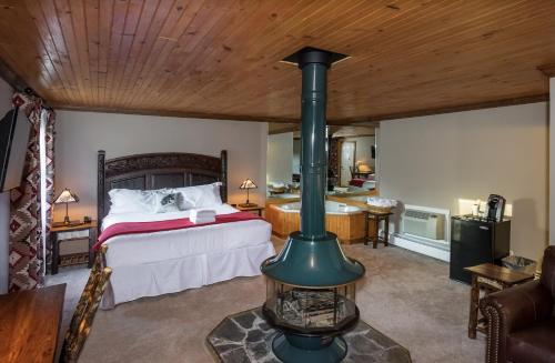 a bedroom with a bed and a wood stove at Great Pines in Old Forge