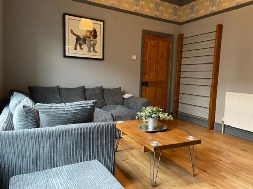 a living room with a couch and a table at Grove House - 4 Bedroom sleeps 8 only 1 mile from centre in Farnley
