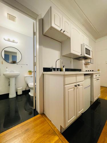 a white kitchen with a sink and a toilet at Hotel and the City, Empire State Building in New York