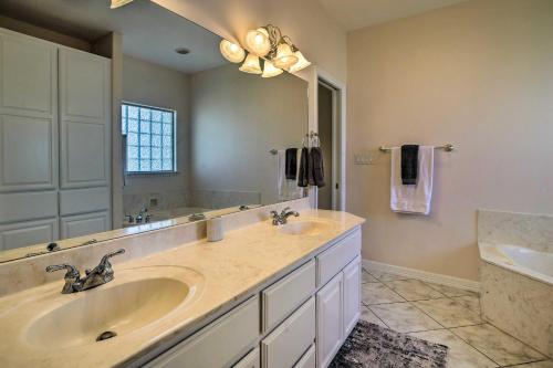 a bathroom with two sinks and a large mirror at Bright Laguna Vista Home with Community Pool! in Laguna Vista