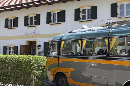 a bus parked in front of a building at Romantik Hotel Chalet am Kiental in Herrsching am Ammersee