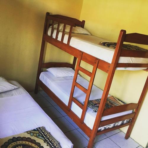 a room with two bunk beds in a room at Hostal Machalilla in Puerto López