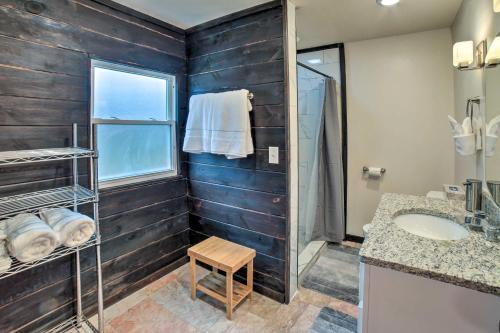 a bathroom with wooden walls and a sink and a window at Indiana Vacation Rental Near Lake Michigan in Valparaiso
