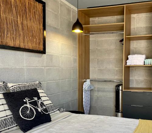 a bedroom with a bike pillow on a bed at Loft industrial vista a los volcanes in Cholula