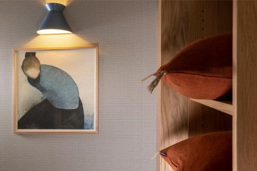 a picture of a man hanging on a wall at Le Petit Oberkampf Hotel & Spa in Paris