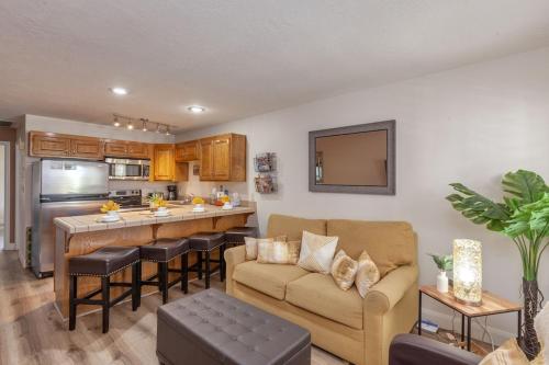 a living room with a couch and a kitchen at LP 124 Mesa Views, Grill, Cable, Great Las Palmas Amenities, and Fully Stocked Kitchen in St. George