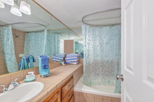 a bathroom with a sink and a tub and a mirror at LP 124 Mesa Views, Grill, Cable, Great Las Palmas Amenities, and Fully Stocked Kitchen in St. George